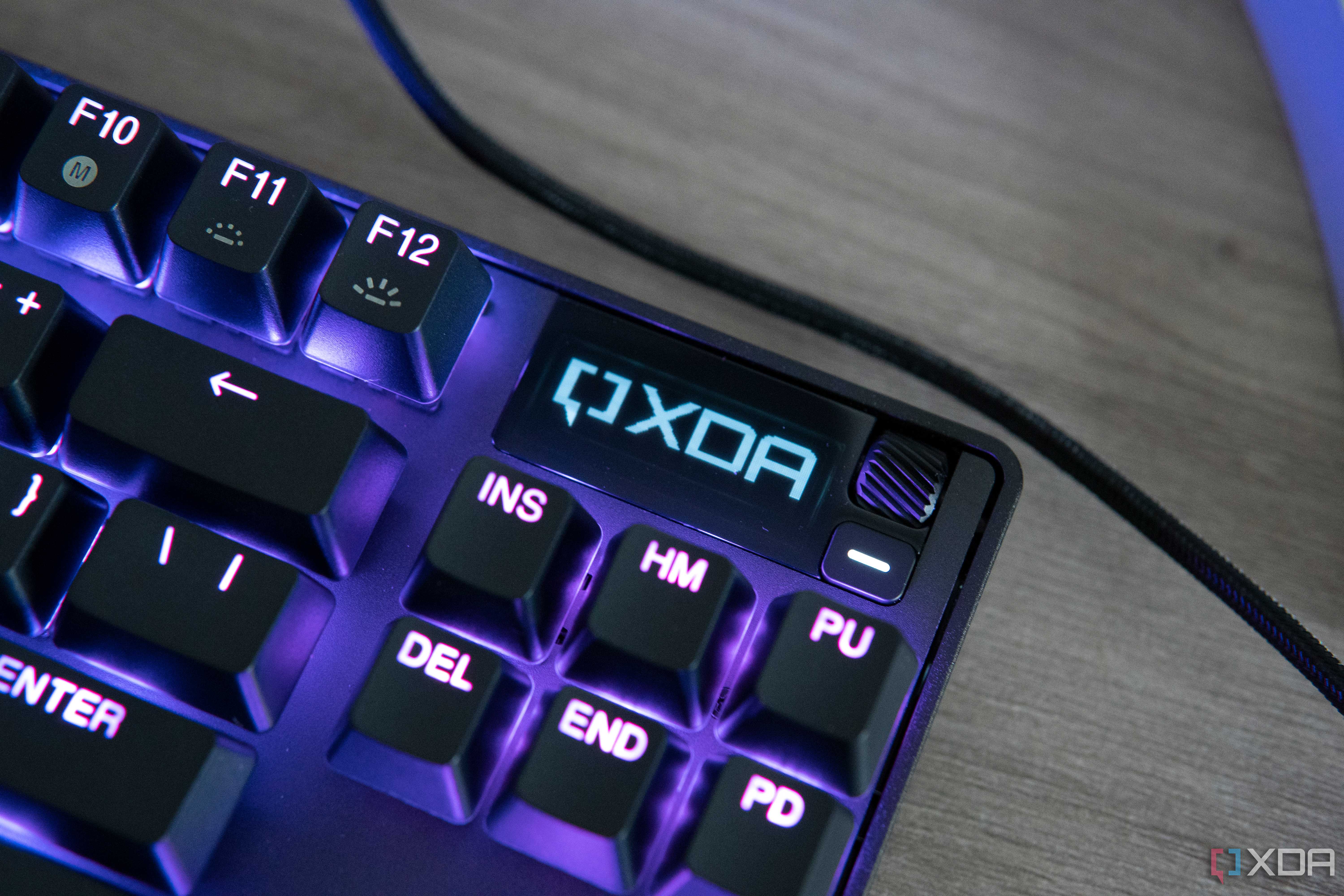 Close-up view of the OLED screen on the SteelSeries Apex Pro TKL displaying the XDA logo