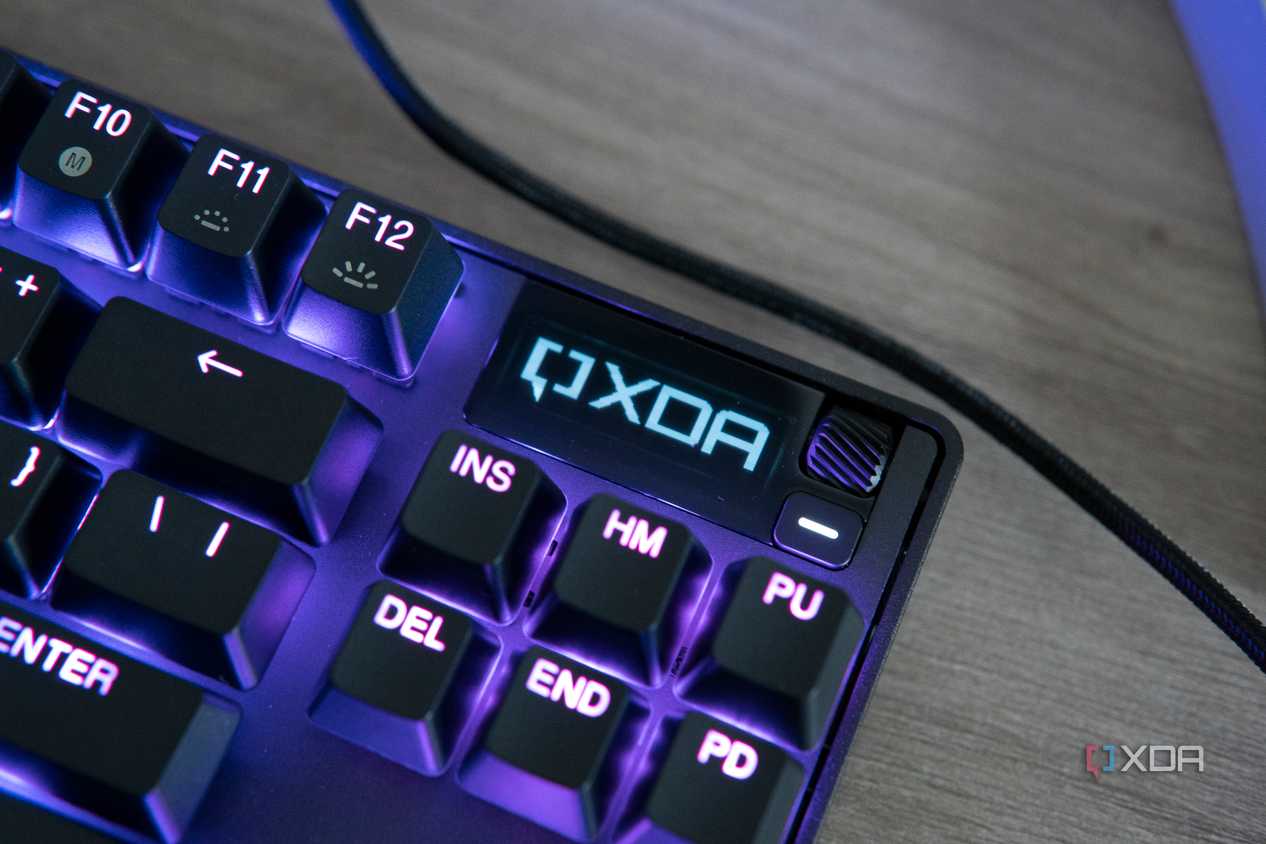 Close-up view of the OLED screen on the SteelSeries Apex Pro TKL displaying the XDA logo