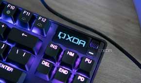Close-up view of the OLED screen on the SteelSeries Apex Pro TKL displaying the XDA logo