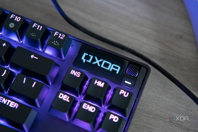 Close-up view of the OLED screen on the SteelSeries Apex Pro TKL displaying the XDA logo