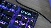 Close-up view of the OLED screen on the SteelSeries Apex Pro TKL displaying the XDA logo