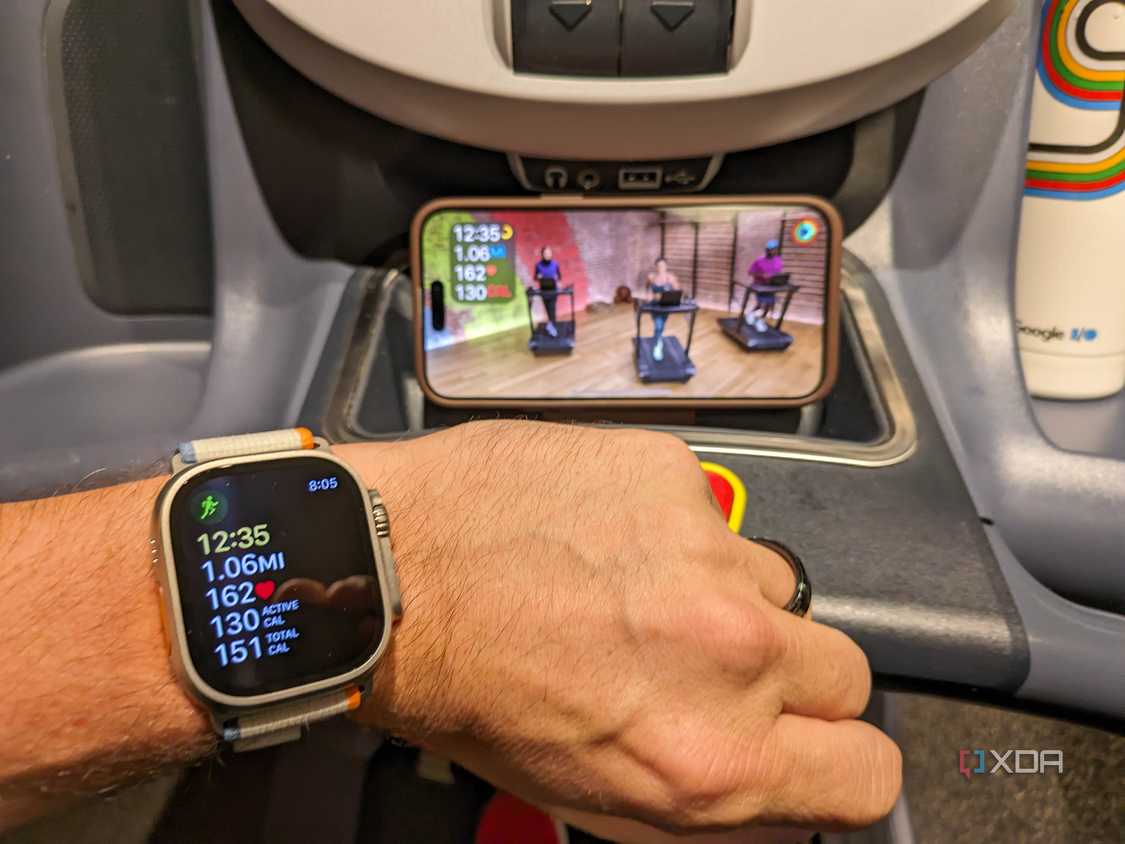 Apple Watch with treadmill workout on display in background
