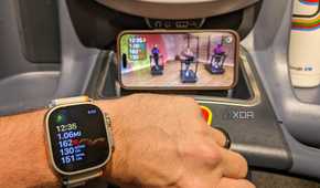 Apple Watch with treadmill workout on display in background