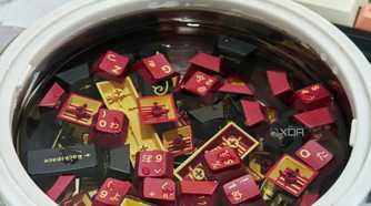 An image showing GMK Red Samurai keycaps soaking in a bowl of lukewarm water.