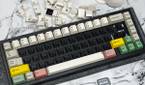 An image showing a mechanical keyboard with no alpha keys next to a keycap puller and a mouse.