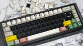 An image showing a mechanical keyboard with no alpha keys next to a keycap puller and a mouse.