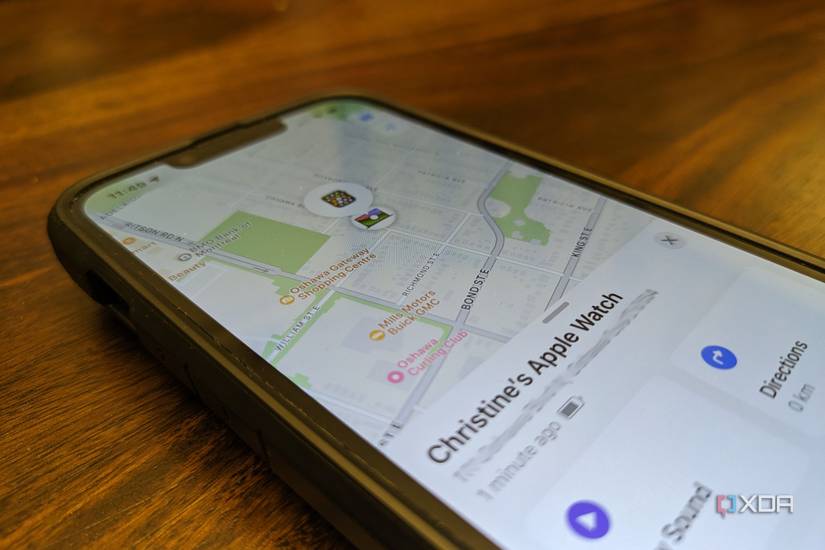 An Apple iPhone lying on a table with the Find My app open showing the location of an Apple Watch.