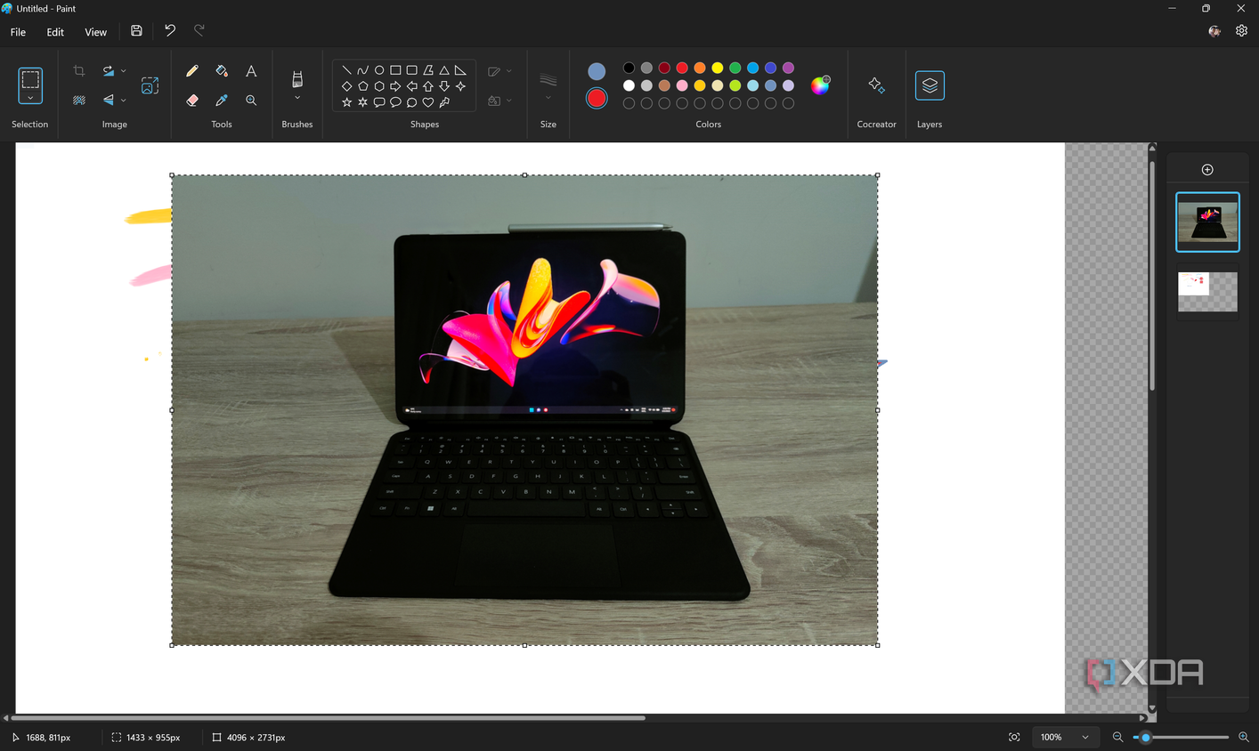 Screenshot of the Paint app in Windows 11 with a layer with a photo of a tablet open on a second layer
