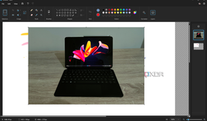 Screenshot of the Paint app in Windows 11 with a layer with a photo of a tablet open on a second layer