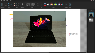 Screenshot of the Paint app in Windows 11 with a layer with a photo of a tablet open on a second layer