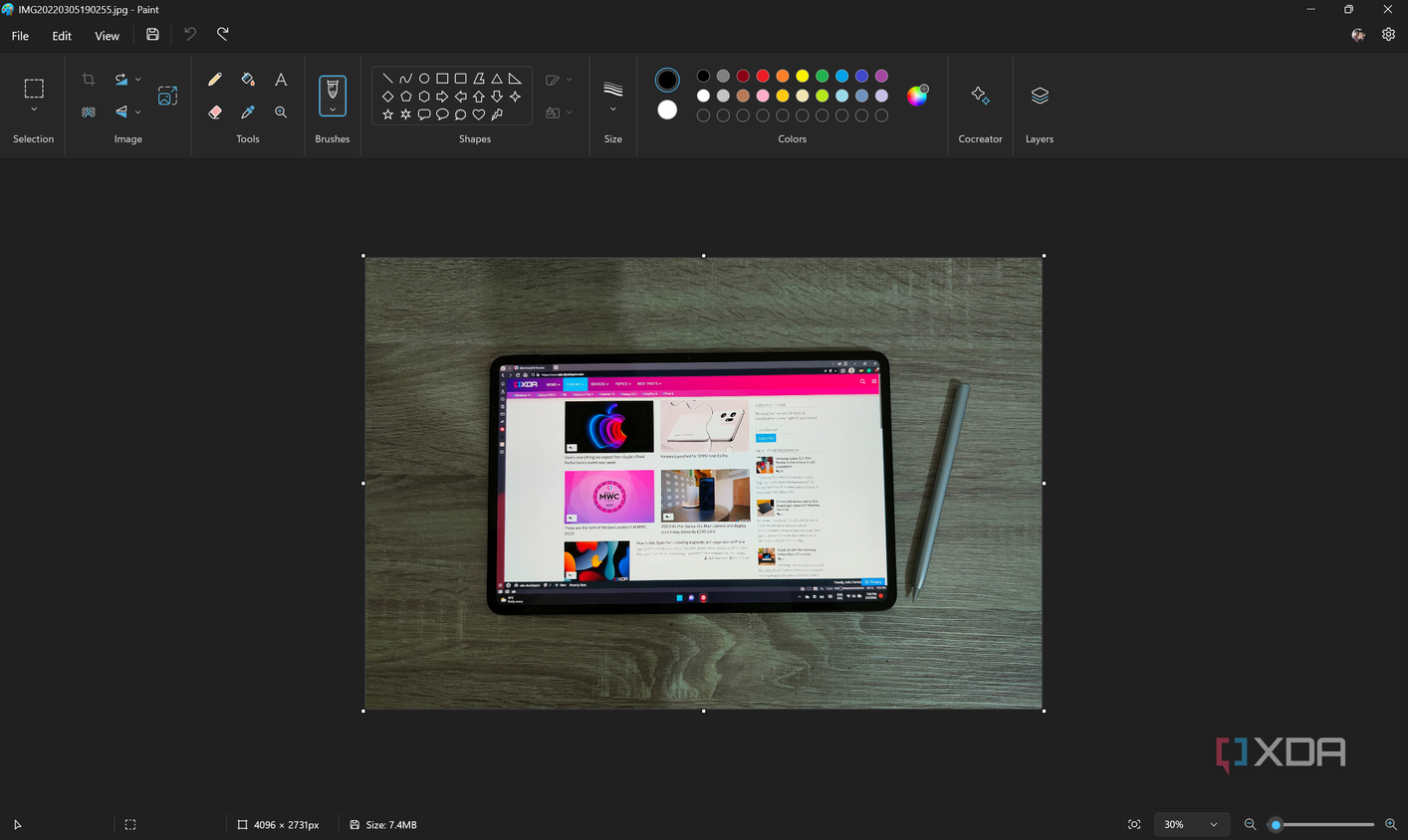 Screenshot of Paint with a picture of a tablet on top of a wooden surface