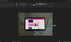 Screenshot of Paint with a picture of a tablet on top of a wooden surface