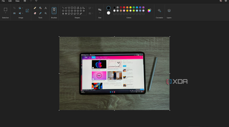 Screenshot of Paint with a picture of a tablet on top of a wooden surface
