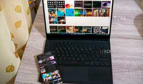 A laptop running intel Unison next to the phone linked to the app. The same photos that are on the phone are visible on the laptop
