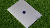 The Starlight color of the MacBook Air (15-inch) on artificial grass.