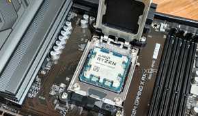 An image showing a Ryzen 7 7800X3D CPU resting on a motherboard's CPU socket.