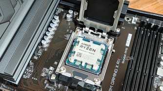 An image showing a Ryzen 7 7800X3D CPU resting on a motherboard's CPU socket.