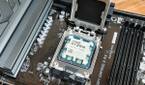 An image showing a Ryzen 7 7800X3D CPU resting on a motherboard's CPU socket.