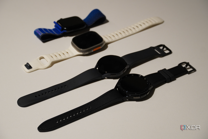 Four smartwatches on a countertop for comparison.