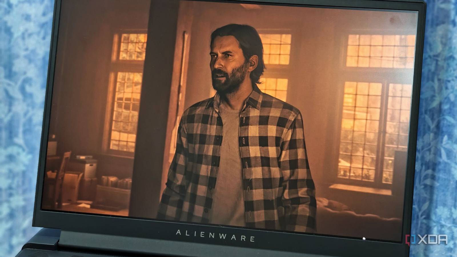 An image showing the Alienware m16 display with Alan Wake 2's screenshot on it.