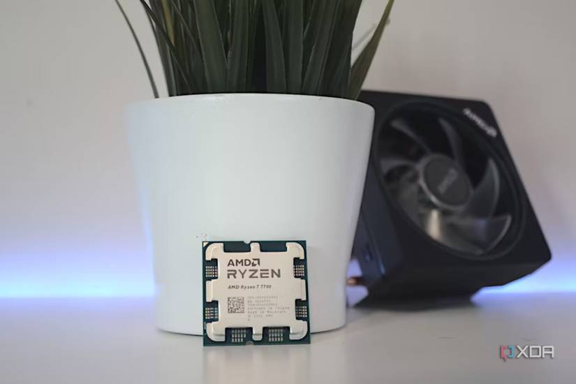 An image showing the AMD Ryzen 7 7700 CPU next to its cooler.