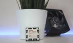 An image showing the AMD Ryzen 7 7700 CPU next to its cooler.