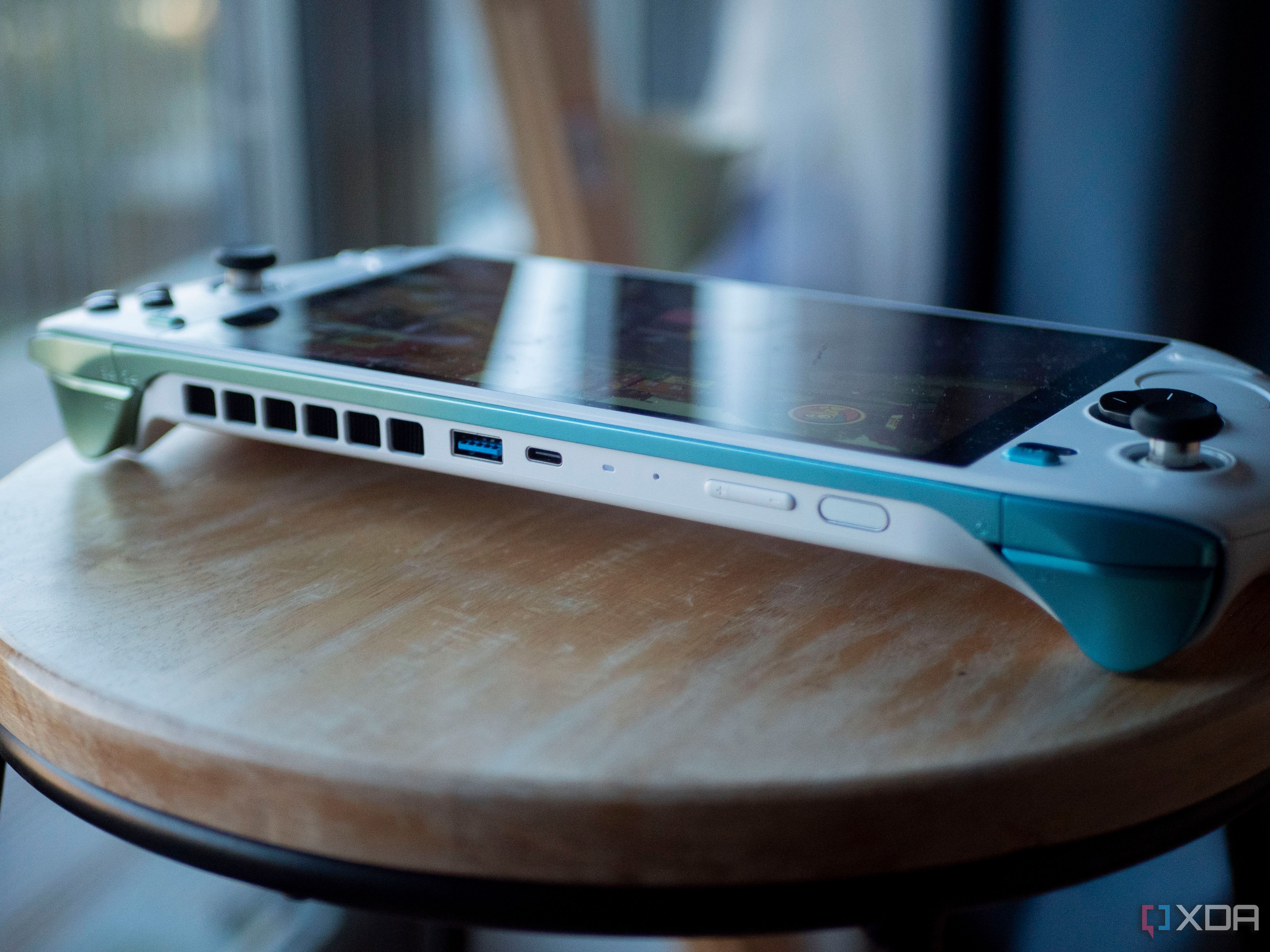 Ayaneo Kun on a stool with USB-A port, USB-C port, fingerprint sensor, and volume rocker