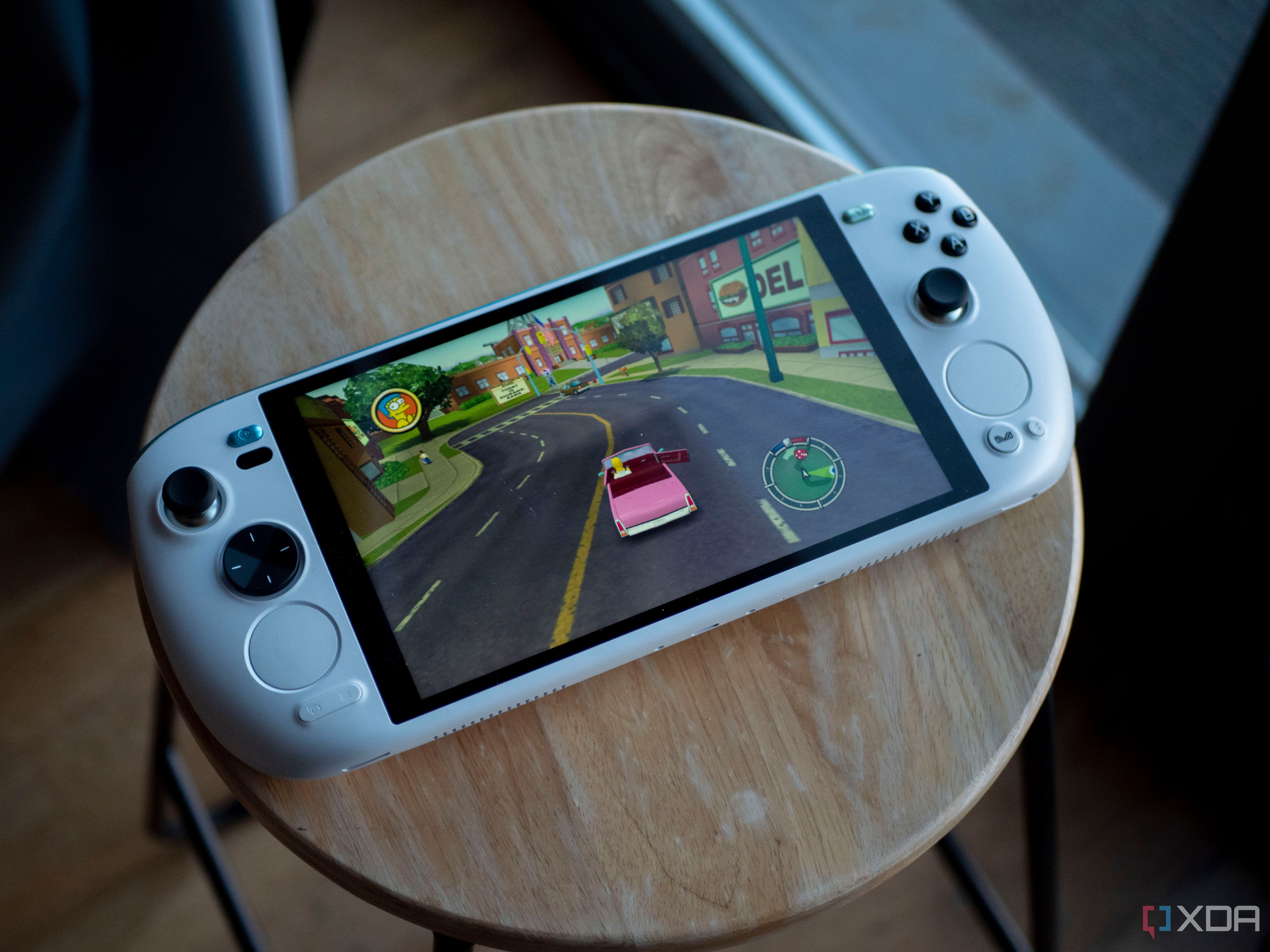 Ayaneo Kun sitting flat on a stool with Simpsons Hit and Run on screen