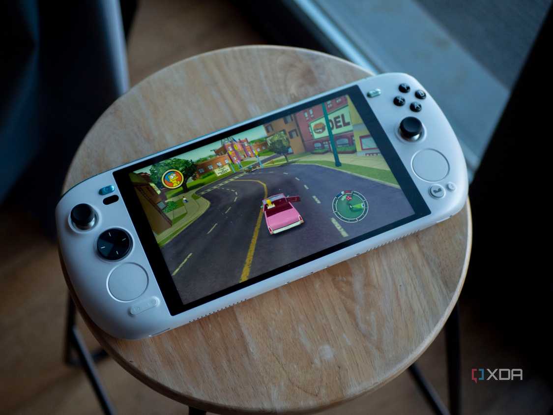 Ayaneo Kun sitting flat on a stool with Simpsons Hit and Run on screen
