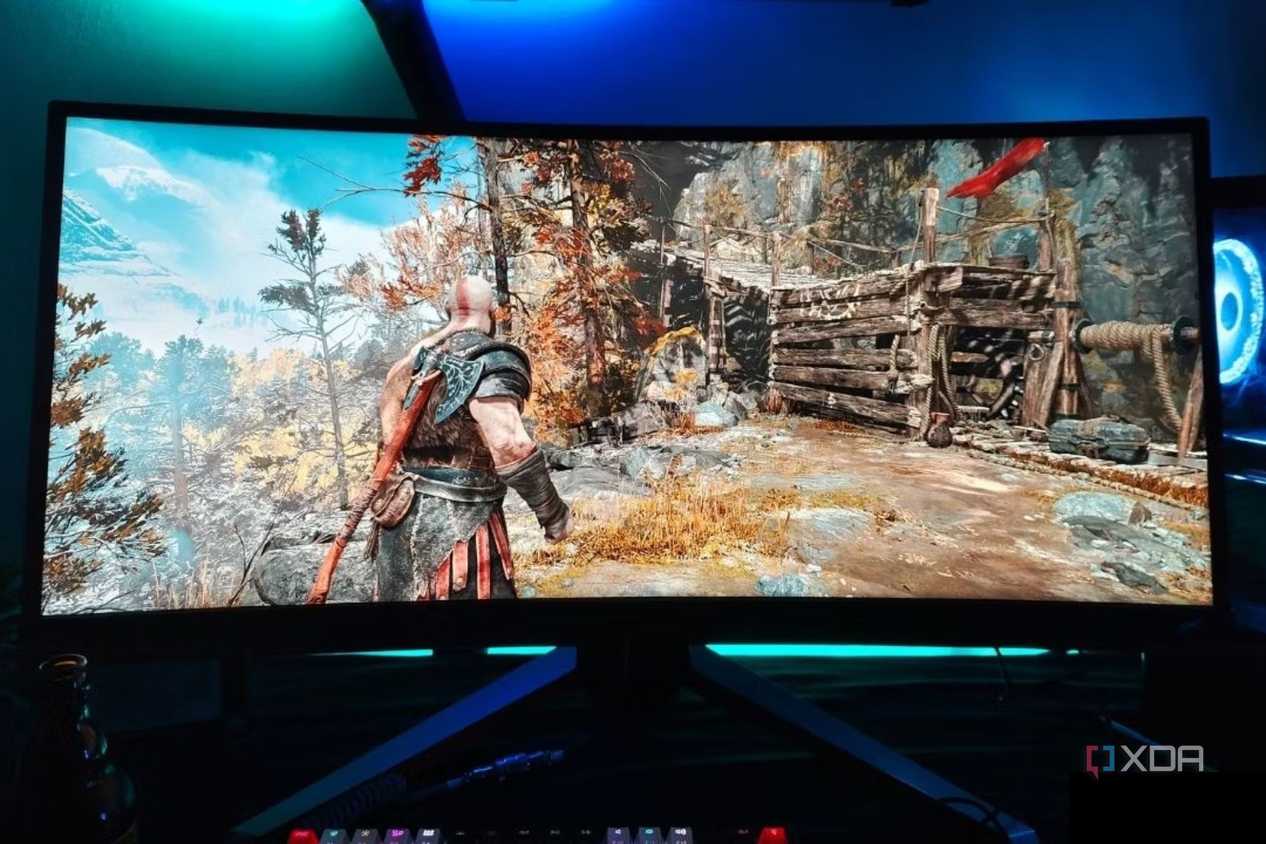 An image showing a Benq Mobiuz ex3415r ultrawide monitor displaying God Of War gameplay.