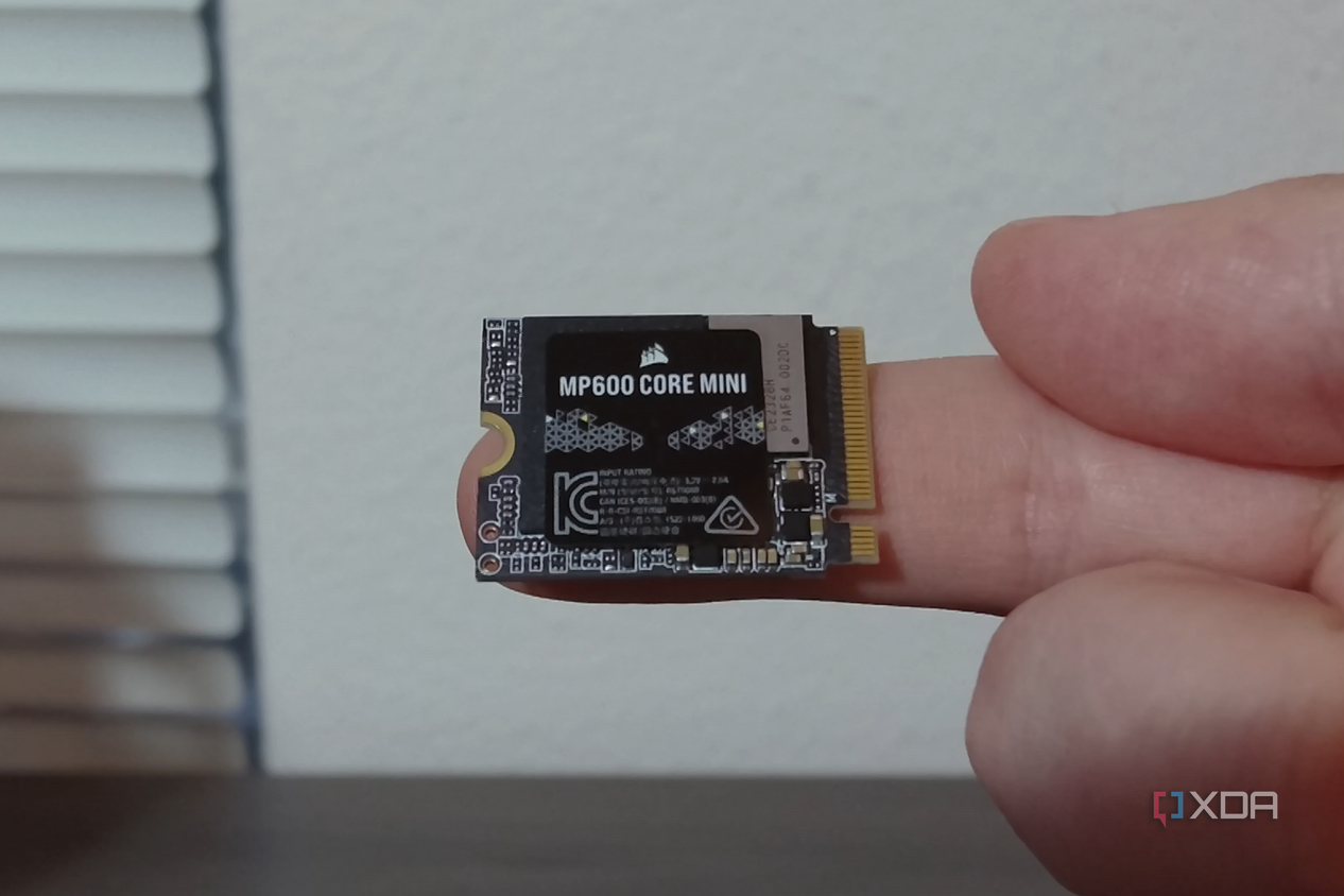 Corsair MP600 Core Mini SSD on a finger.