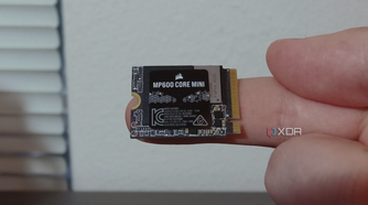 Corsair MP600 Core Mini SSD on a finger.