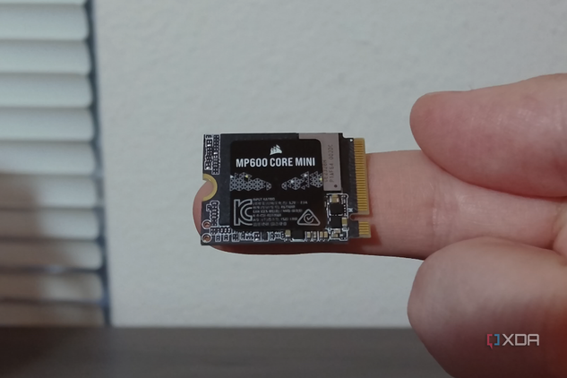 Corsair MP600 Core Mini SSD on a finger.