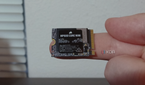 Corsair MP600 Core Mini SSD on a finger.