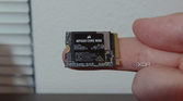 Corsair MP600 Core Mini SSD on a finger.