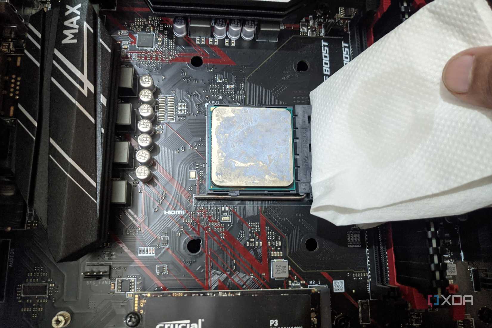 An image of the Ryzen 5 1600 processor with a paper towel dipped in isopropyl alcohol