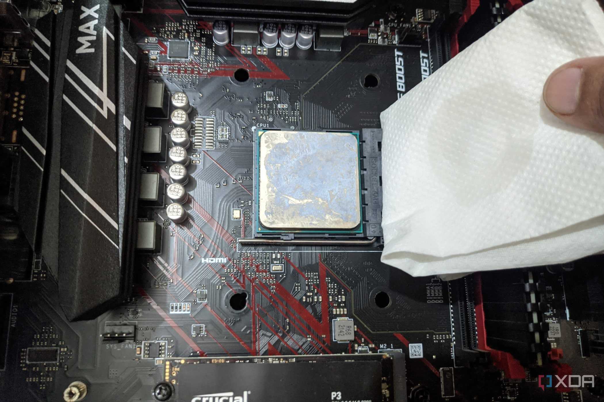 An image of the Ryzen 5 1600 processor with a paper towel dipped in isopropyl alcohol