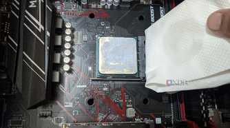 An image of the Ryzen 5 1600 processor with a paper towel dipped in isopropyl alcohol