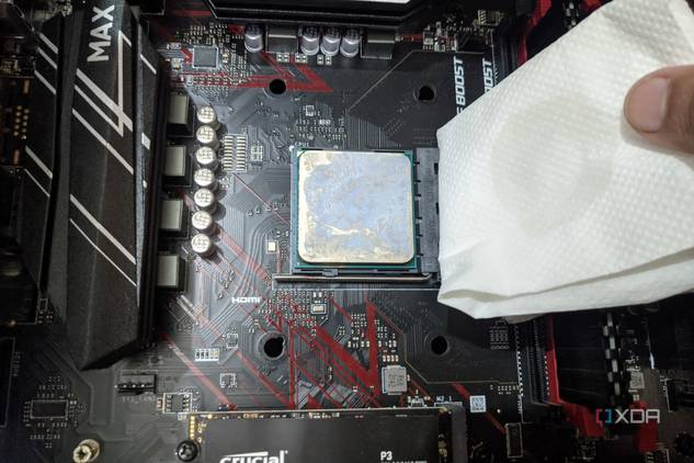 An image of the Ryzen 5 1600 processor with a paper towel dipped in isopropyl alcohol