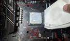 An image of the Ryzen 5 1600 processor with a paper towel dipped in isopropyl alcohol