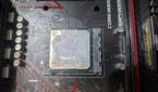 An image of the AMD Ryzen 1600 with thermal paste smeared all over it