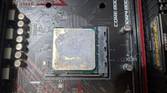 An image of the AMD Ryzen 1600 with thermal paste smeared all over it