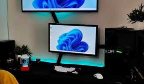 An image showing a dual monitor setup with lots of cables running around the setup.