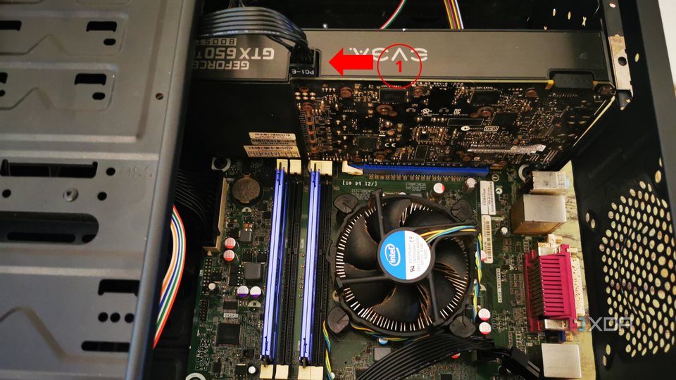 An open computer case showing an installed graphics card with a numbered label indicating the PCIE power cable.