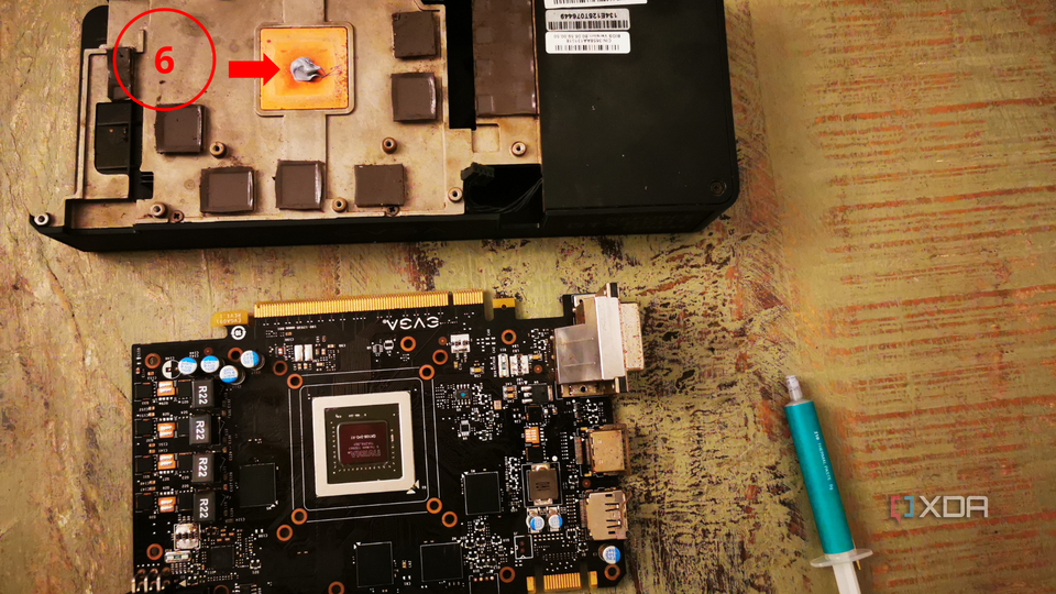 A graphics card next to its heatsink, with new thermal paste on the heatsink, marked with a label for step six.