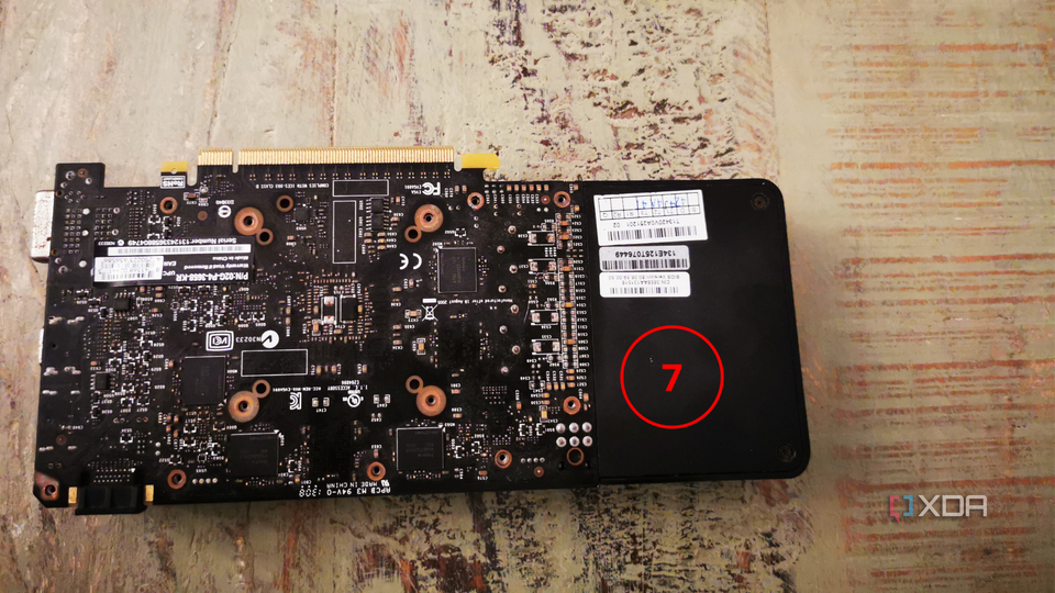 A graphics card with the back panel re-attached but not screwed in.
