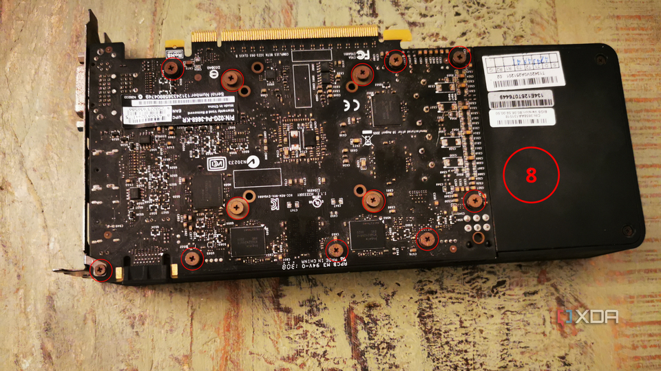 Detailed view of the graphics card's circuitry and with circles over the screws with a label for step eight.