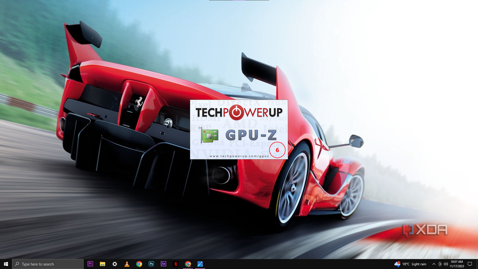 A desktop background featuring a red sports car with the GPU-Z program window open in the foreground, displaying the software's logo and web address.