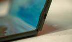 Close up of USB-C port on the side of a laptop with a foldable screen, partially folded