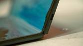 Close up of USB-C port on the side of a laptop with a foldable screen, partially folded